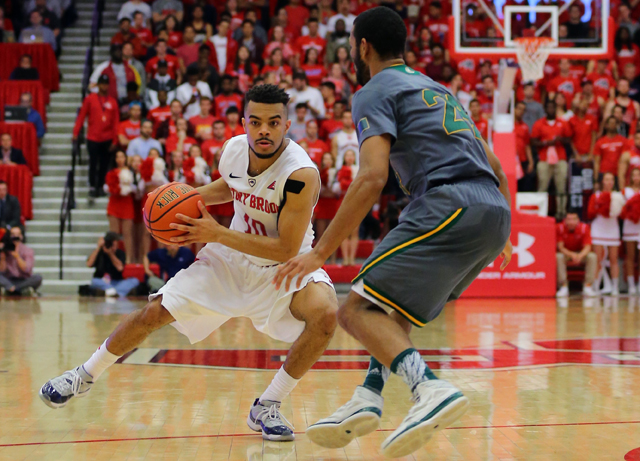 Stony Brook guard Carson Puriefoy drives to the net during the second half of Stony Brook's American East Championship victory over Vermont at Stony Brook University's Island FCU Arena Sunday. (Credit: Daniel De Mato)