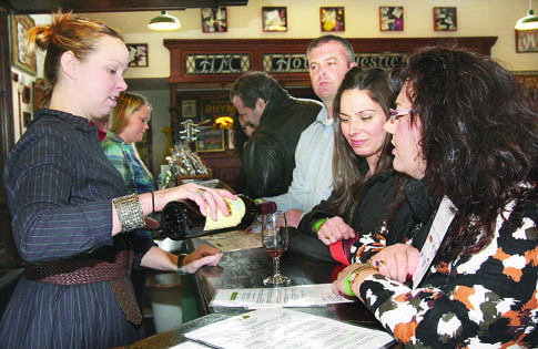 Palmer Vineyards tasting room manager Bridget Micielli-Martinez pours merlot cuvée for guests Saturday afternoon, when the Aquebogue vineyard hosted the Tim Siciliano Trio for Winterfest Jazz on the Vine. Winterfest, a project of East End Arts Council, Long Island Wine Council and Long Island Convention and Visitors Bureau, continues at local wineries through March 20. Visit liwinterfest.com for the schedule of performances.