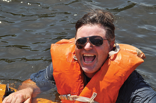 Matt Van Glad of Riverhead didn't make it very far during this year's Cardboard Boat Race on the Peconic River. (Credit: Grant Parpan)