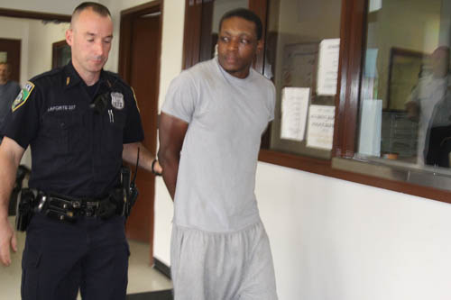 JENNIFER GUSTAVSON PHOTO | Paul Thompson is led into Riverhead Town Justice court during an arraignment proceeding last month.