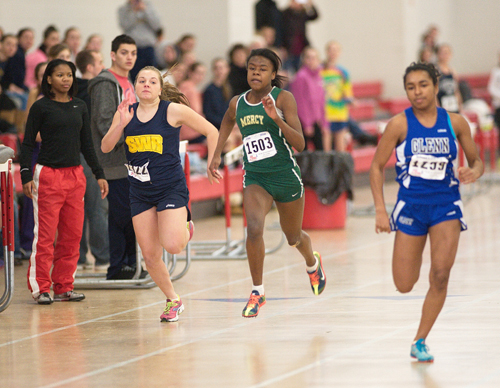 GARRET MEADE PHOTO  |  McGann-Mercy junior Danisha Carter races in the 55-meter dash alongside Shoreham-Wading River freshman Megan Kelly.