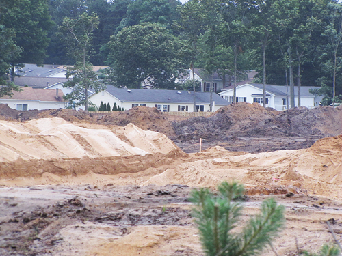 TIM GANNON FILE PHOTO | Excavation at the site of a future Costco on Route 58 stretches up to neighboring homes in Foxwood Village.