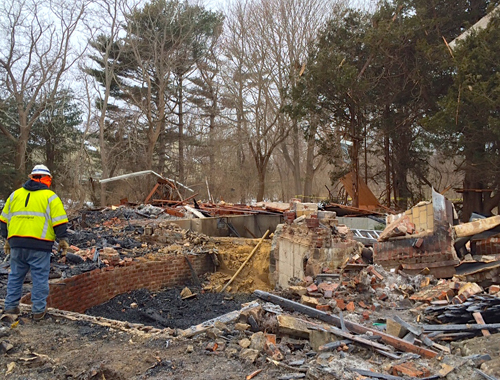 A worker surveys the scene at last week's Water Mill explosion. (Credit: Christine Fuge courtesy photo)