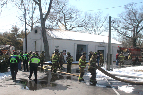 PAUL SQUIRE PHOTO | Riverhead firefighters at the scene of Sunday afternoon's fire.