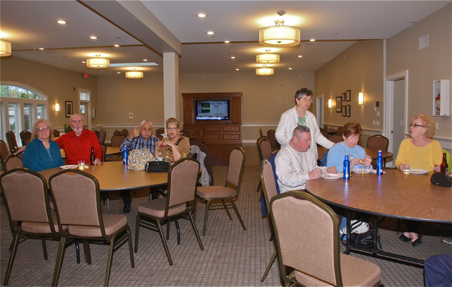 Glenwood Recreation Center president Catherine Eyester (standing) talks with fellow residents in the renovated clubhouse. (Credit: Barbaraellen Koch)