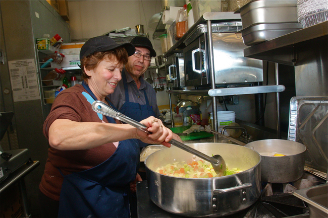 Ioanna and Manolis Kavvadias cooking up vegetables for soup Friday morning at Greek Bites Grill in Mattituck. (Credit: Barbaraellen Koch)