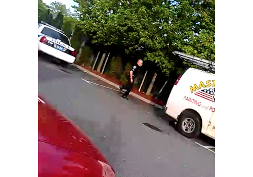 WITNESS COURTESY PHOTO | Police storm a work van during Tuesday's drug bust outside Laundry Palace near Route 58 in Riverhead.