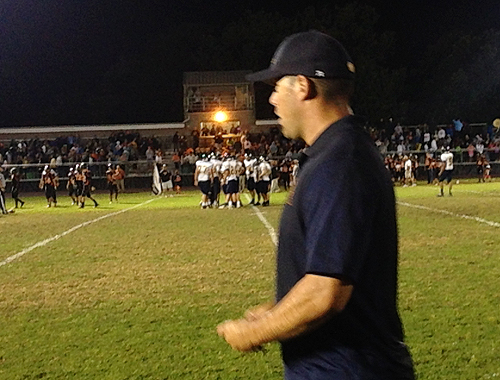 Shoreham-Wading River coach Matt Millheiser receive a surprise ice shower after the Wildcats' upset victory over Babylon Friday. (Credit: Joe Werkmeister)