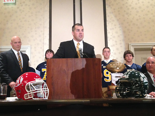 Shoreham-Wading River coach Matt Millheiser accepts the Rutgers Trophy on the team's behalf at Monday night's all-county dinner. (Credit: Joe Werkmeister)