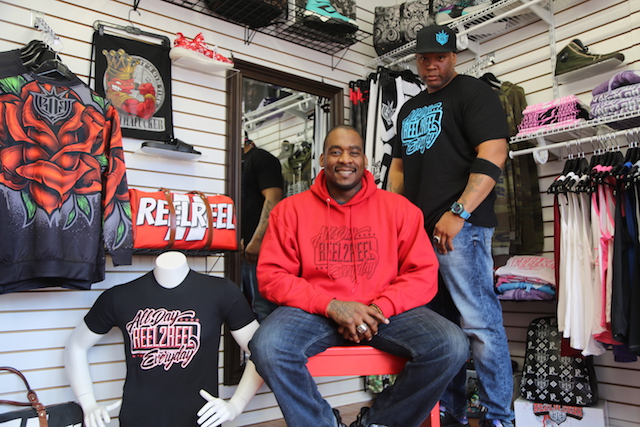 Photo caption: Shawn Diming (left) and Rashad Lawson opened their showroom for Reel2Reel last month on Griffing Avenue in Riverhead. They sell hand-designed clothing, backpacks and other apparel items. (Rachel Siford)