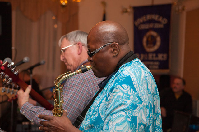 Mike Ryan & Friends' Paulie Ortegosa on saxophone and Mike Ryan on guitar.