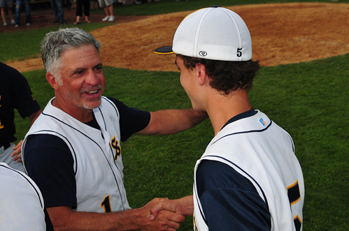 Shoreham-Wading River coach Sal Mignano celebrates the team's 2012 county championship with catcher Jack Massa. (Credit: Bill Landon, file)