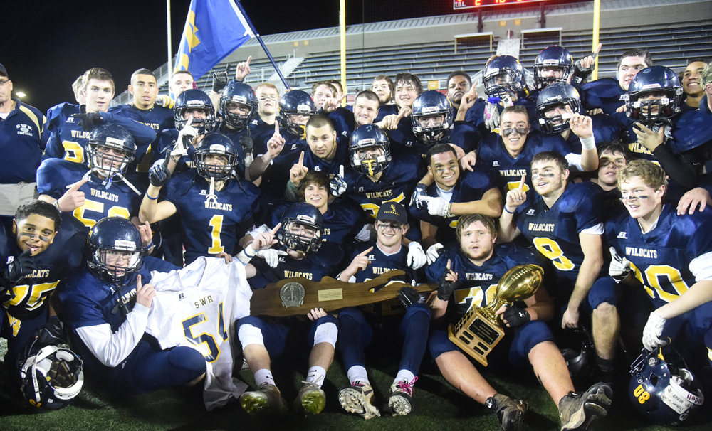 The Shoreham-Wading River football team celebrates its 2014 Long Island Championship win over Roosevelt. (Credit: Robert O'Rourk, file)