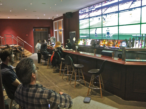 PAUL SQUIRE PHOTO | Joe Goglia (left) and another All-Star manager play a game of FIFA 13 on the bowling alley's 21-foot TV screen.