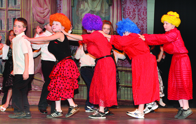 Riley Avenue Elementary School students presented 'Cinderella' March 12 at Riverhead High School. The prince, played by R.J. Stueber, leads stepsisters (from left) Michael Cunningham, Ryan Keane, Jacob Nitti and Michael Krulder in a dance at the ball.