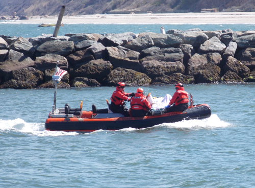 Members of the U.S. Coast Guard boat into the Mattituck Inlet on the morning Ciro Stellges' body was found in the water. (Credit: Joseph Pinciaro, file)