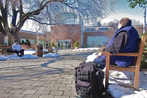 Former taxi driver Charlie, homeless since September, sits outside the Riverhead Free Library one recent afternoon. (Credit: Barbaraellen Koch, file)