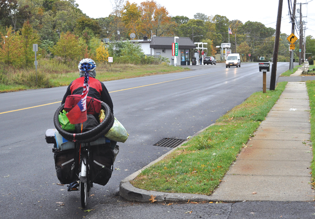 Jason Tang leads the Times/Review office following an interview on his way to Glen Head. (Credit: Joe Werkmeister)