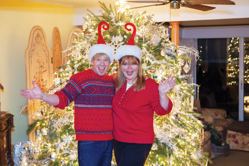Kevin and Tammy Kruger at their Mechanic Street home in Southold. Mr. Kruger said the couple's main Christmas tree, located in the living room, is decked out in all-white lights, decorations and ornaments that took 20 years to collect. (Credit: Katharine Schroeder)