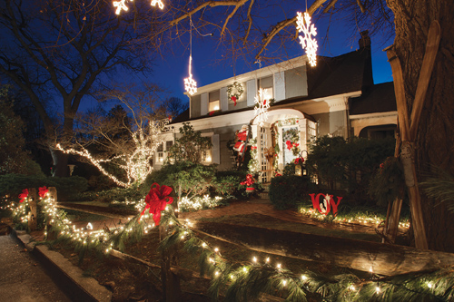A life-sized sculpture of Santa Claus climbing a ladder takes center stage in the winter wonderland that Kevin and Tammy Kruger start working on each November on Mechanic Street in Southold. (Credit: Katharine Schroeder)