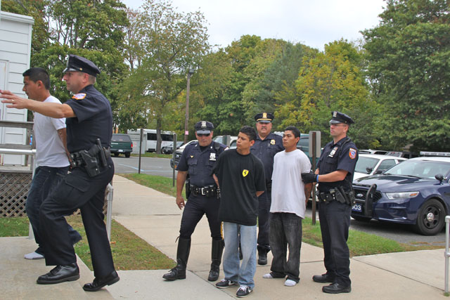 Southold Town police lead the three shooting suspects into Southold Town Justice Court Wednesday afternoon. (Credit: Carrie Miller)
