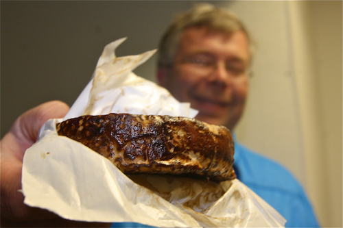 Hal Goodale shows off a soft-ripped cheese brined in Long Ireland’s Black Friday Imperial Stout beer. (Credit: Barbaraellen Koch)