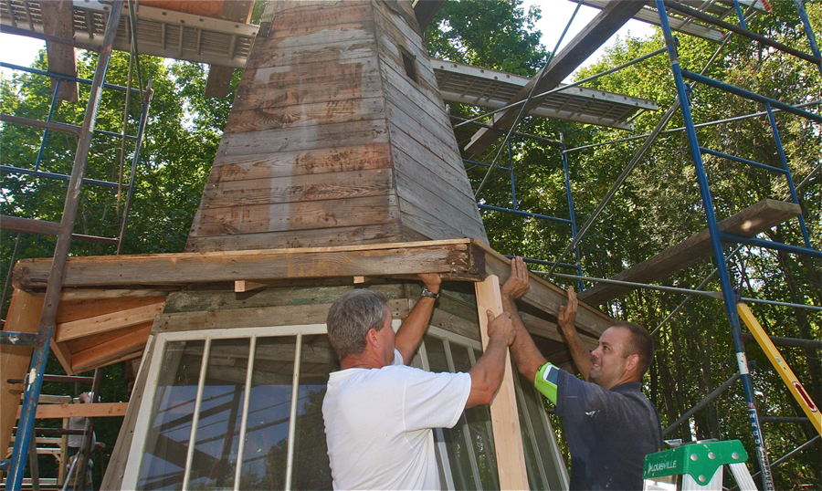 Randy Clement (left) and Mile Weber Jr. of Clement Carpentry of Jamesport working on the Witch's Hat restoration Thursday morning.