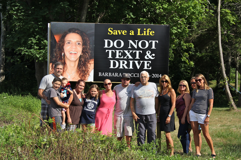 A sign on Route 24 warns drivers of the dangers of texting and driving following the death of Barbara Tocci on the road earlier this year. (Credit: Carrie Miller, file)